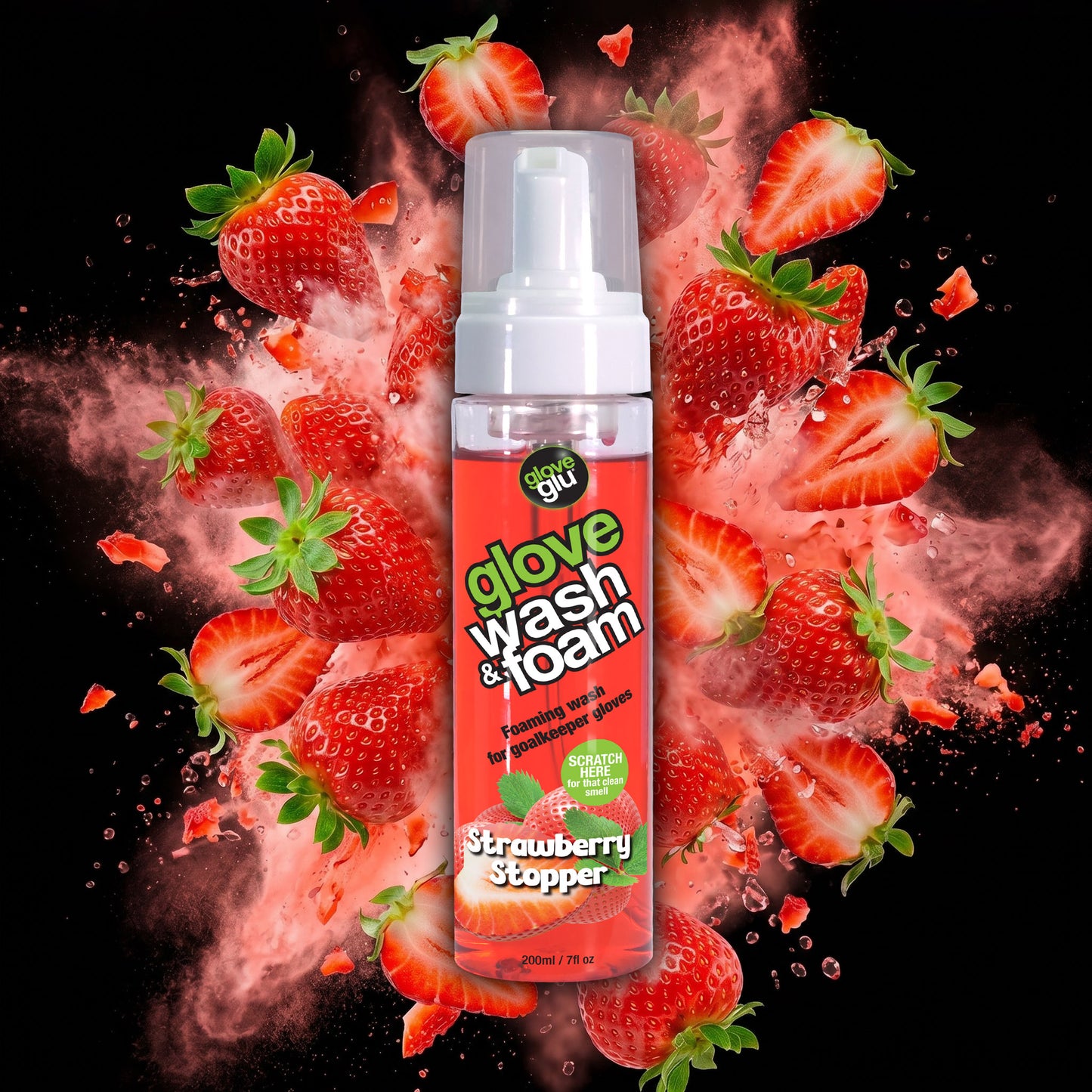 A bottle of wash & foam with a splash of spray and strawberries behind it